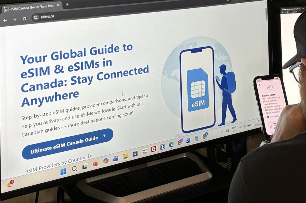 Founder of eSIMs.ca working at a computer while setting up an eSIM